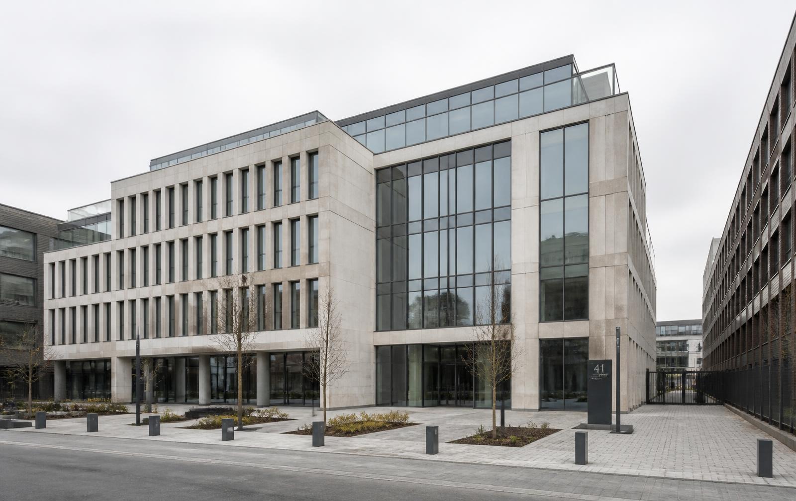Bürogebäude mit Glas- und Steinfassade in ruhigem Tageslicht